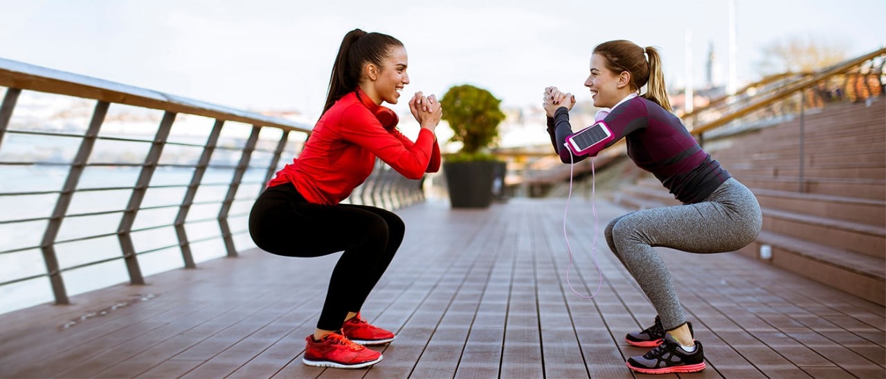 Two women exercising outside